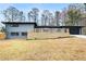 Home exterior showcasing a wooden deck, grey brick, and an expansive front yard at 1120 Taliwa Ne Trl, Marietta, GA 30068