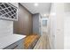 Hallway with built-in wood bench, gray cabinets, wine rack and hardwood floors at 1120 Taliwa Ne Trl, Marietta, GA 30068
