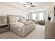 Beautiful main bedroom featuring a ceiling fan, tray ceiling, and a seating area near the windows at 1616 Aiden Way # 65, Conyers, GA 30013