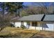Inviting single-story home with white siding, a blue front door, and a well-manicured lawn at 170 Roberts Rd, Covington, GA 30016