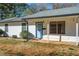 Welcoming single-story home featuring a covered front porch, neat landscaping, and a blue front door at 170 Roberts Rd, Covington, GA 30016