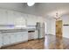 Updated kitchen featuring stainless steel appliances, white cabinets, granite countertops, and hardwood floors at 170 Roberts Rd, Covington, GA 30016