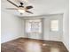 Bright living room with a ceiling fan, wood-look floors, and a view of the outdoor landscape at 170 Roberts Rd, Covington, GA 30016