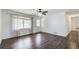 Spacious living room with dark wood floors, a ceiling fan, and large window that streams in natural light at 170 Roberts Rd, Covington, GA 30016