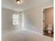 Bedroom with neutral carpeting features a window and door to the attached bathroom at 2221 Croghan Dr, Hampton, GA 30228