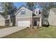 Charming two-story home with brick accents, a two-car garage, and a well-maintained front yard at 2221 Croghan Dr, Hampton, GA 30228