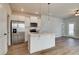 Modern kitchen featuring white cabinets, stainless steel appliances, and a central island with pendant lighting at 2221 Croghan Dr, Hampton, GA 30228