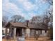 A side view of a distressed single-story home with a chimney and a yard at 3072 Semmes St, East Point, GA 30344