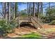 Wooden footbridge surrounded by lush greenery and trees at 4865 Northway Dr, Atlanta, GA 30342