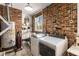 Functional laundry room with exposed brick, modern appliances, and storage shelves at 4865 Northway Dr, Atlanta, GA 30342