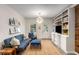 Comfortable living room featuring a blue sofa, built-in shelving, and modern decor at 4865 Northway Dr, Atlanta, GA 30342