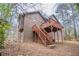 Two story home featuring a backyard with a wooden deck and stairs at 123 Williamsburg Ln, Woodstock, GA 30189