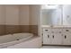 Bathroom featuring tiled flooring and a large bathtub with shower head at 123 Williamsburg Ln, Woodstock, GA 30189