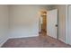 Bedroom with a beige carpet and walls, with an open door leading to another room at 123 Williamsburg Ln, Woodstock, GA 30189