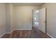 Neutral bedroom with beige carpet and walls, and an open door leading to another room at 123 Williamsburg Ln, Woodstock, GA 30189