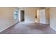 Bedroom with beige walls, carpet and multiple doorways leading to closet and bathroom at 123 Williamsburg Ln, Woodstock, GA 30189