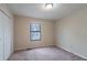 Cozy bedroom with a window for natural light and a double-door closet at 123 Williamsburg Ln, Woodstock, GA 30189