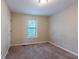 Cozy bedroom featuring neutral walls and plush carpeting with window bringing in natural light at 123 Williamsburg Ln, Woodstock, GA 30189