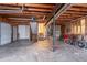 Large garage with a side door, exposed pipes, and stairs leading to another area at 123 Williamsburg Ln, Woodstock, GA 30189