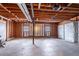 Spacious garage with concrete floors, exposed wood framing, and a white garage door at 123 Williamsburg Ln, Woodstock, GA 30189