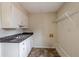 Functional kitchen featuring a stainless steel sink, white cabinetry, and durable countertops at 123 Williamsburg Ln, Woodstock, GA 30189