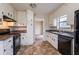 Well-lit kitchen features granite countertops, modern appliances, and white cabinets at 123 Williamsburg Ln, Woodstock, GA 30189