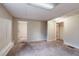 Spacious living room with carpeted flooring, neutral walls, and doorways leading to other rooms at 123 Williamsburg Ln, Woodstock, GA 30189