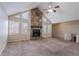 Bright living room featuring a stone fireplace and a ceiling fan, with multiple windows at 123 Williamsburg Ln, Woodstock, GA 30189