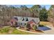 Aerial view of red brick home with dormer windows, front porch, and circular driveway at 211 Garden W Walk, Hampton, GA 30228