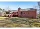 Exterior of brick home featuring a deck, screened in porch, and chimney at 211 Garden W Walk, Hampton, GA 30228