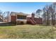 Exterior of brick home featuring a deck, screened in porch, and chimney at 211 Garden W Walk, Hampton, GA 30228