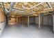 Unfinished basement with exposed ductwork, concrete flooring, and wooden supports ready to be transformed at 211 Garden W Walk, Hampton, GA 30228