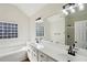 Bathroom features a double vanity, soaking tub, framed mirrors, and a tiled shower at 211 Garden W Walk, Hampton, GA 30228