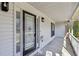 Inviting front porch featuring a decorative glass front door and white railings at 211 Garden W Walk, Hampton, GA 30228