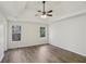 Spacious main bedroom featuring trey ceilings, hardwood floors, two large windows at 211 Garden W Walk, Hampton, GA 30228