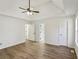 Bright main bedroom features neutral walls, trey ceilings, and hardwood floors at 211 Garden W Walk, Hampton, GA 30228