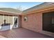 Open brick patio with screen door and doggie door, brick wall, and painted wood plank floor at 211 Garden W Walk, Hampton, GA 30228