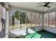 Enclosed screened porch with ceiling fan, offering a tranquil space with views of the lush backyard at 211 Garden W Walk, Hampton, GA 30228