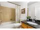 Cozy bathroom with tiled walls, tub with shower, and granite vanity top at 301 Madison Se Ct, Smyrna, GA 30080