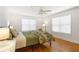 Bright bedroom with hardwood floors, ceiling fan, and natural light from two windows at 301 Madison Se Ct, Smyrna, GA 30080