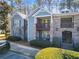 View of lovely condo building with stacked stone accents, private balconies, and manicured landscaping at 301 Madison Se Ct, Smyrna, GA 30080