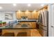 Well-lit kitchen featuring stainless steel appliances, granite countertops, and custom wood cabinetry at 301 Madison Se Ct, Smyrna, GA 30080