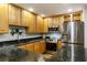 Bright kitchen with stainless steel appliances, granite countertops, and ample wood cabinet storage at 301 Madison Se Ct, Smyrna, GA 30080