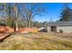 Large backyard featuring a well-maintained lawn, deck, mature trees, and a privacy fence at 3140 Westmart Ln, Atlanta, GA 30340