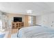 Relaxing bedroom features wood-look floors, large mirror and a flat screen television at 3140 Westmart Ln, Atlanta, GA 30340