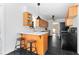 Modern kitchen with black floors, light wood cabinets, and bar seating at 3140 Westmart Ln, Atlanta, GA 30340