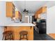 Bright kitchen featuring black floors, light wood cabinets, and bar stools at 3140 Westmart Ln, Atlanta, GA 30340