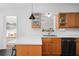 Kitchen with quartz countertops, wooden cabinets, a serving window, and black dishwasher at 3140 Westmart Ln, Atlanta, GA 30340