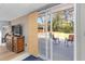 Stylish living room with sliding glass doors to deck, hardwood floors, and a charming wood console table at 3140 Westmart Ln, Atlanta, GA 30340