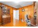 Wood-paneled office featuring a desk with hutch, ample storage, and a comfortable rolling chair at 3140 Westmart Ln, Atlanta, GA 30340